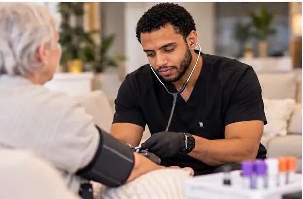 Carlos checking a patient's blood pressure
